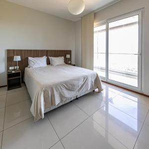 เตียงในห้องที่ Asunción Rent Suites Santa Teresa