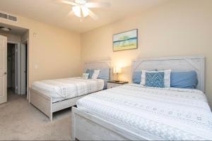 a bedroom with two beds and a ceiling fan at spacious two bedroom 2 bath close to Disney Adventure Park in Anaheim