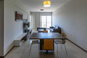a living room with a dining room table and chairs at Asunción Rent Suites Santa Teresa in Asuncion