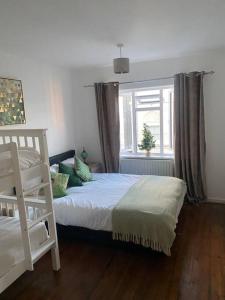 a bedroom with a white bed and a window at Brighton NEW Apartment FREE PARKING sleeps 6 in Brighton & Hove