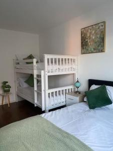a bedroom with a white bunk bed and a white bunk ladder at Brighton NEW Apartment FREE PARKING sleeps 6 in Brighton & Hove