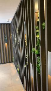 a hallway with a black and white fence with plants at MAGİA HOTEL in Istanbul