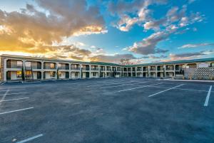 an empty parking lot in front of a building at Angoria Hotel in San Angelo