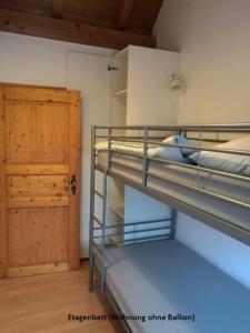 アルテッティンにあるFerienwohnungen zentral Altöttingの二段ベッド2台とドアが備わる客室です。