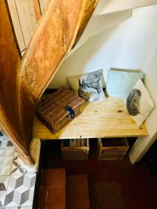 a cat sitting on a wooden bench in a room at La Petite Ardoise - Maison au calme pour 4 pers in Honfleur