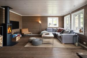 a living room with a couch and a fireplace at Nesfjellet in Nes i Ådal