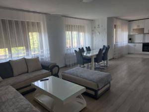 a living room with a couch and a table at Apartmanii Gajić in Kuršumlija