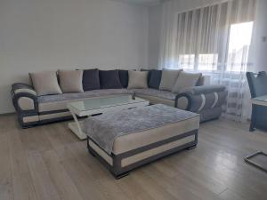 a living room with a couch and a coffee table at Apartmanii Gajić in Kuršumlija