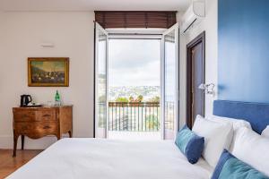 Postel nebo postele na pokoji v ubytování Terrazza Monteroduni 16