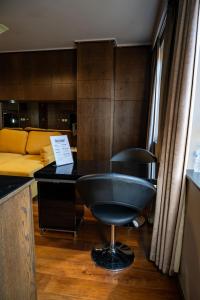 a desk with a chair in a room with a couch at Luxury Studio Flat Victoria SW1 in London