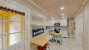 a kitchen with a table and a dining room at BEACHY SISTERS B Duplex in Jekyll Island