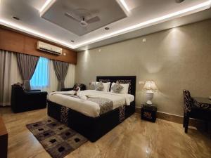 a bedroom with a large bed in a room at Arpita Beach Resort in Chandīpur