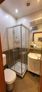 a bathroom with a shower and a toilet and a sink at Apartments Miljas 1 in Dubrovnik +86 photos