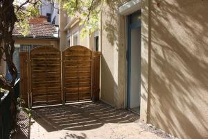 a pair of wooden gates in front of a building at La terrasse du JULES in Romans-sur-Isère