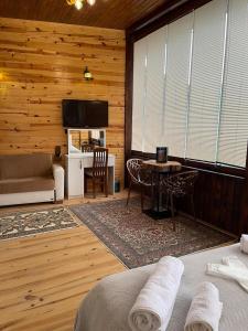 1 dormitorio con 1 cama, TV y mesa en Aho dağ manzaralı oda en Trebisonda