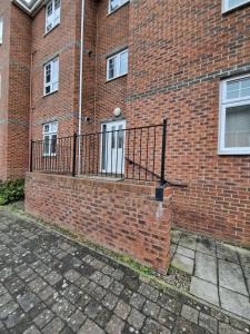 a brick building with a gate on the side of it at Impeccable 2-Bed Apartment in Newcastle upon Tyne in Newcastle upon Tyne