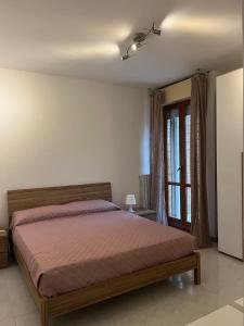 a bedroom with a bed and a window at Pretty house in Rome