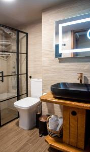 a bathroom with a sink and a toilet at Polytelia Apartment Karystos in Karistos +12 photos
