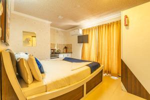 a bedroom with a large bed in a room at Seasons Suites JP Nagar in Bangalore