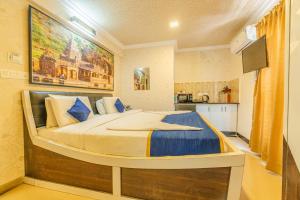 a bedroom with a large bed in a room at Seasons Suites JP Nagar in Bangalore