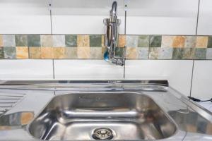 a kitchen sink with a faucet on top of it at 52 LOFT quadruplo · LOFT perto da São Paulo EXPO edo metrô Jabaguara in São Paulo