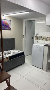 a room with a bed and a refrigerator in it at 52 LOFT quadruplo · LOFT perto da São Paulo EXPO edo metrô Jabaguara in São Paulo