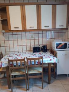 a kitchen with a table with chairs and a microwave at Bonito apartamento Cistierna in Cistierna