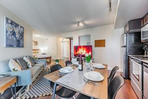 a living room with a table and a couch at Fort York Apartments in Toronto