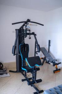 a gym with a chair in a room at SANDS AND ROCKS APARTMENT in Mombasa