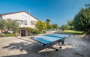 a ping pong table in front of a house at Villa Viktoria poll&garden view in Kaštelir