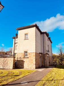 a large brick building with a blue sky in the background at Lakeland Living - Devenish Manor in Enniskillen