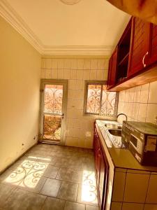 a kitchen with a sink and a stove top oven at Nicole Residence in Yaoundé
