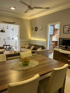 a living room with a dining room table and a couch at Masa Aqaba Apartments in Aqaba