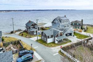 an aerial view of a large house on the water at Charming Westbrook Cottage, Steps to Private Beach in Westbrook