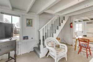 a living room with two chairs and a television at Charming Westbrook Cottage, Steps to Private Beach in Westbrook