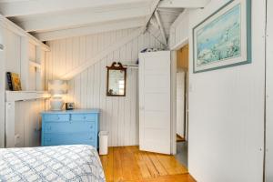 a bedroom with a bed and a blue dresser at Charming Westbrook Cottage, Steps to Private Beach in Westbrook