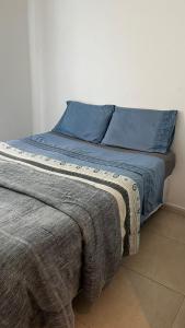 Uma cama ou camas num quarto em Pousada Pé na Areia Rio das Ostras