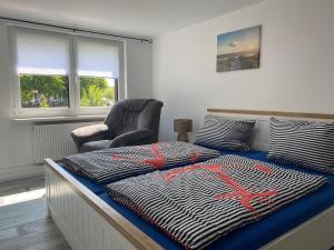 a bedroom with a bed with a red spider on it at Kuestenkind in Lobbe