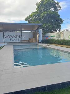 a swimming pool in front of a building at Ale Contel in Lapu Lapu City