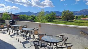 a row of tables and chairs on a patio at Apartamentos Cuerda Larga in Madrid
