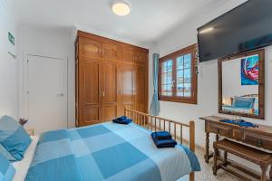 a bedroom with a bed and a mirror and a piano at Atico Garamar in Garachico