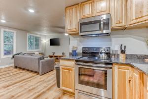 a kitchen with a stove top oven next to a couch at Mt Air Unit 4 · At the base of Mt Hood, family suite 4 in Mount Hood Village