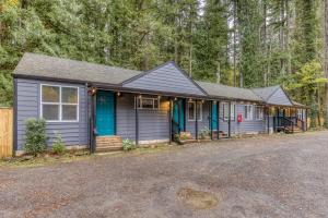 a small house with blue doors in the woods at Mt Air Unit 4 · At the base of Mt Hood, family suite 4 in Mount Hood Village