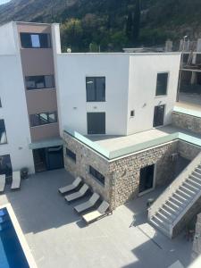 an aerial view of a building with a swimming pool at WolfMoon in Herceg-Novi