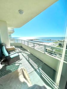 a room with a balcony with a view of the beach at Just Beachy Get-away in Biloxi