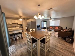 a kitchen and living room with a table and chairs at Cozy Ocean Springs Get-away in Ocean Springs