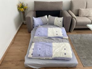 a bed in a living room with a couch at Home im Pott - Sehr Zentral - 4 Pers, TV in Gelsenkirchen