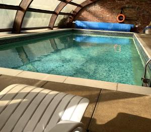 uma piscina com um banco em frente em Moortown House em Market Rasen