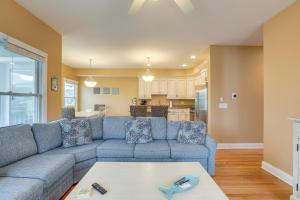 a living room with a blue couch and a table at Long Beach Island Townhome with Rooftop Deck! in Long Beach