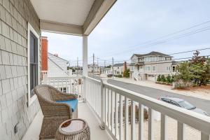 a balcony with a wicker chair and a view of a street at Long Beach Island Townhome with Rooftop Deck! in Long Beach